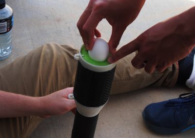 Team Sputnik loads egg payload in rocket. Recovery of an unbroken egg was a competition metric